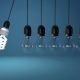 Energy-saving bulb beside traditional light bulbs